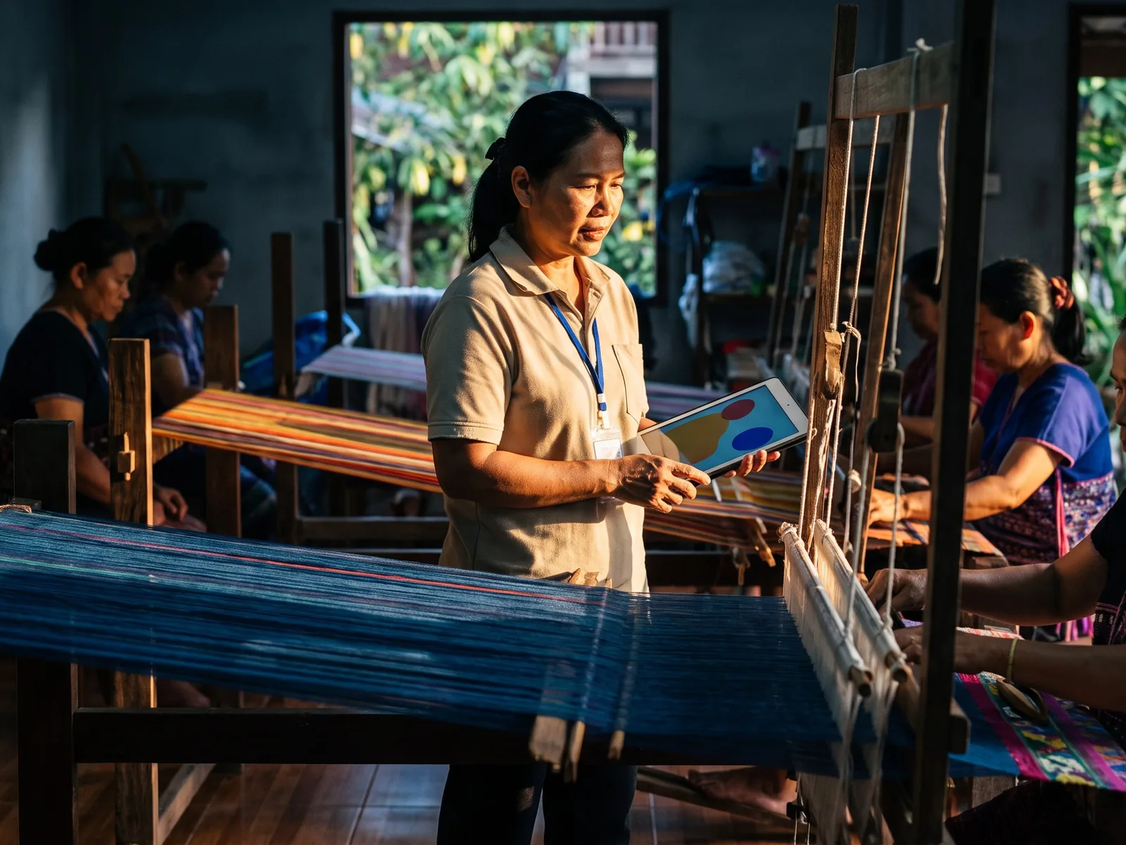 Field officer recording products with local weavers in northern Thailand